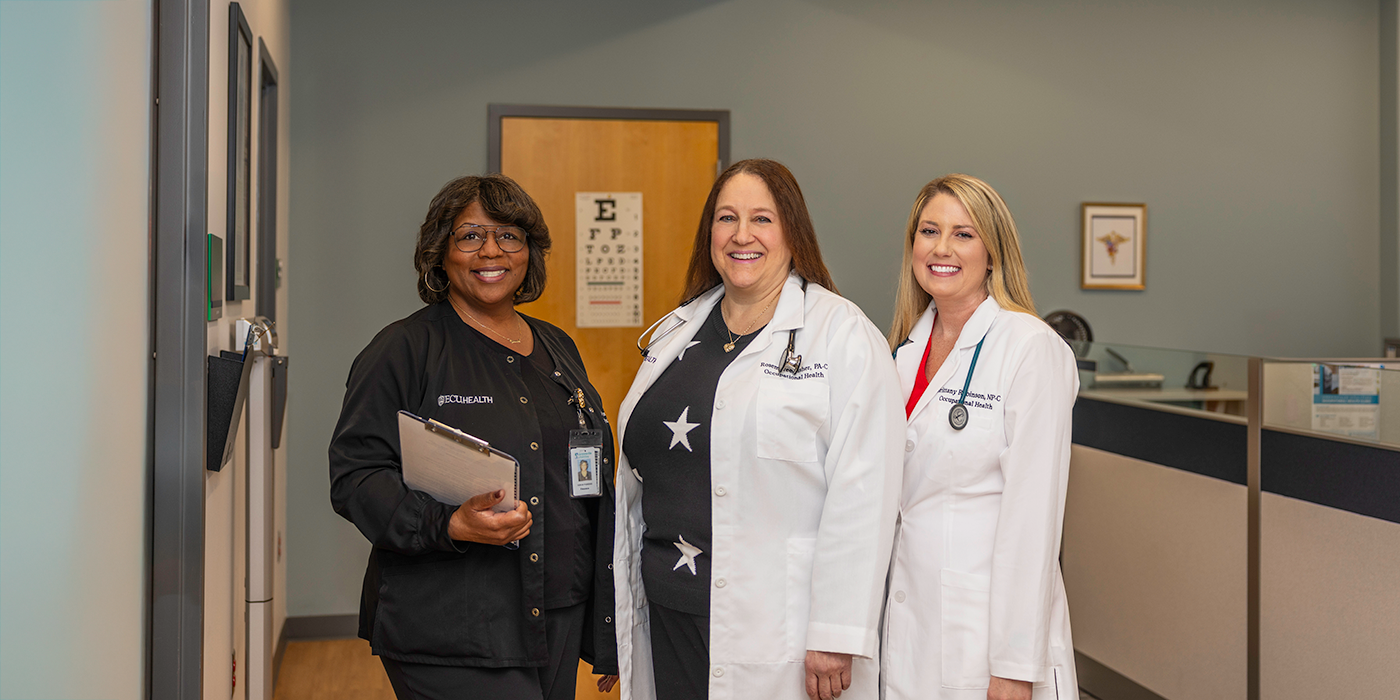 Three clinic staff members pose for photo